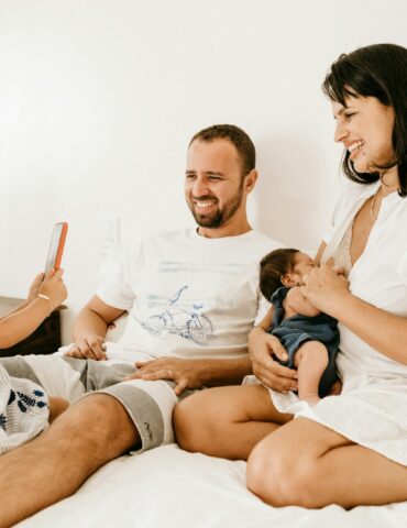 man in white crew neck t-shirt sitting beside woman in white crew neck t-shirt