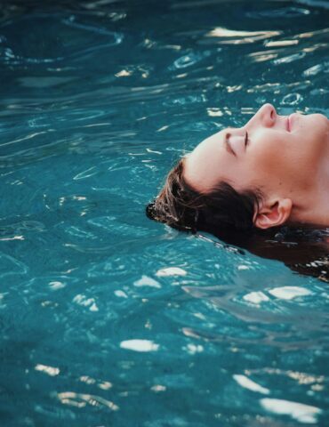 woman floating on body of water