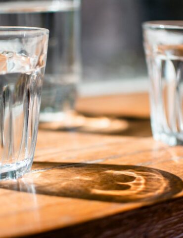 three clear drinking glass on table